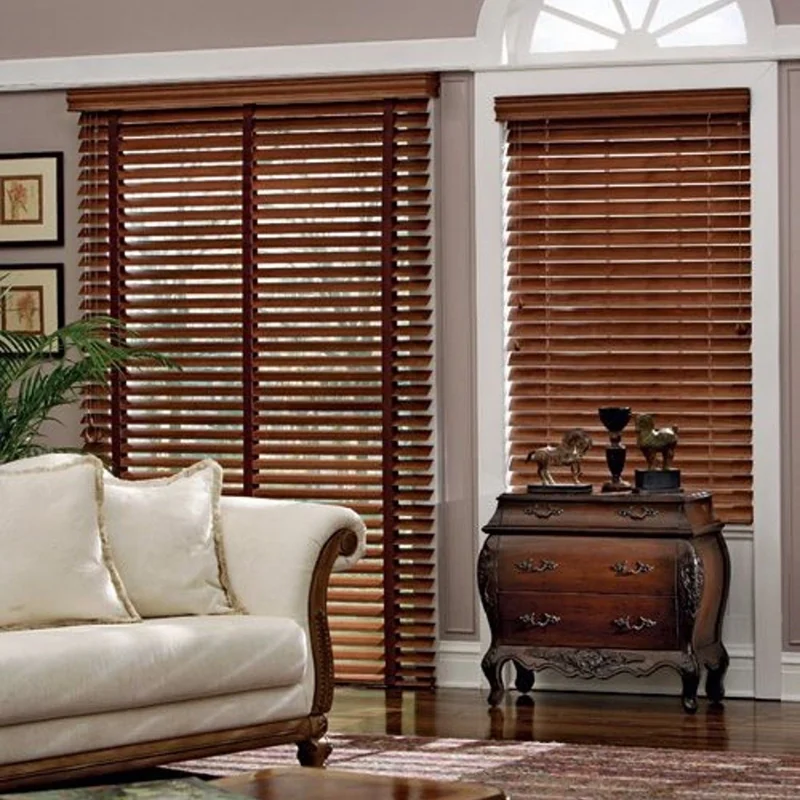 Living room window with dark wooden blinds and furniture