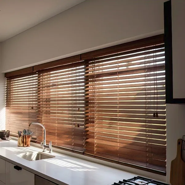 Warm wooden blinds over a kitchen sink.