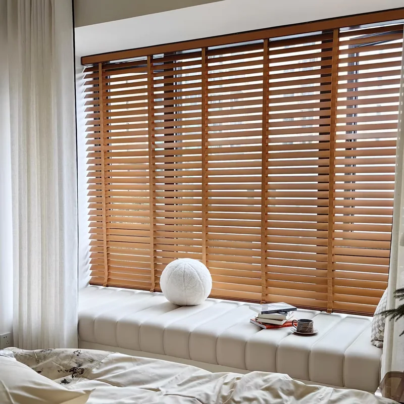 Wooden blinds over a window seat with white cushions.