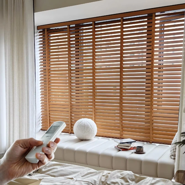 Hand holding remote for motorized wooden blinds