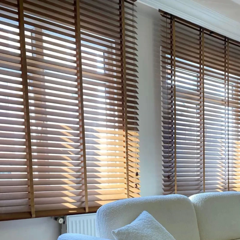 Wooden blinds filtering sunlight on windows